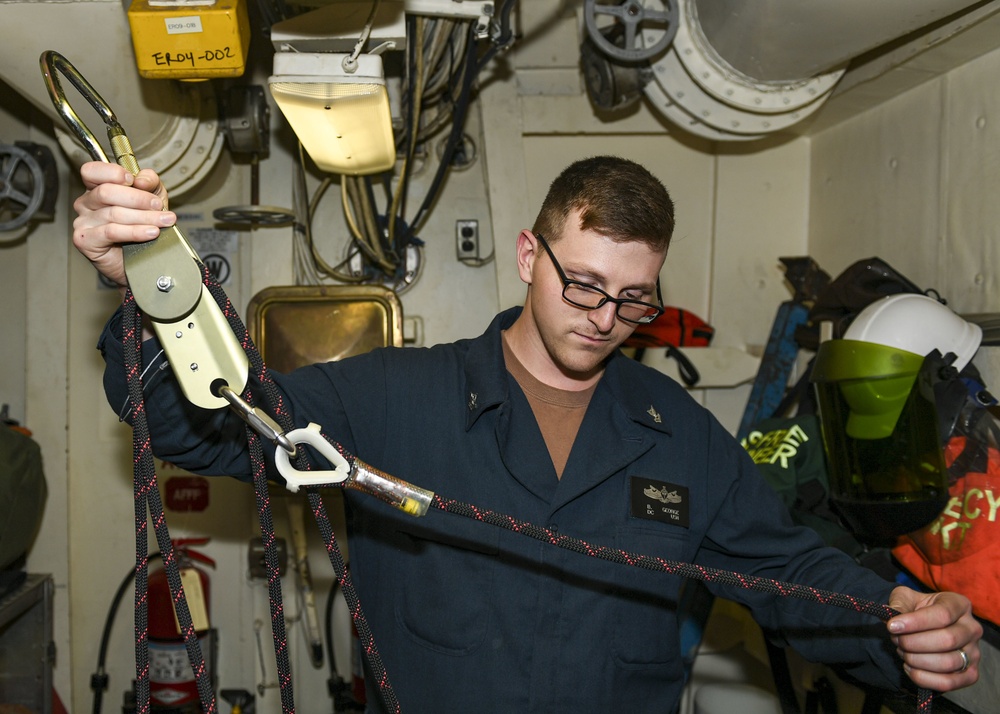 USS Normandy Sailor Inspects Rescue Equipment