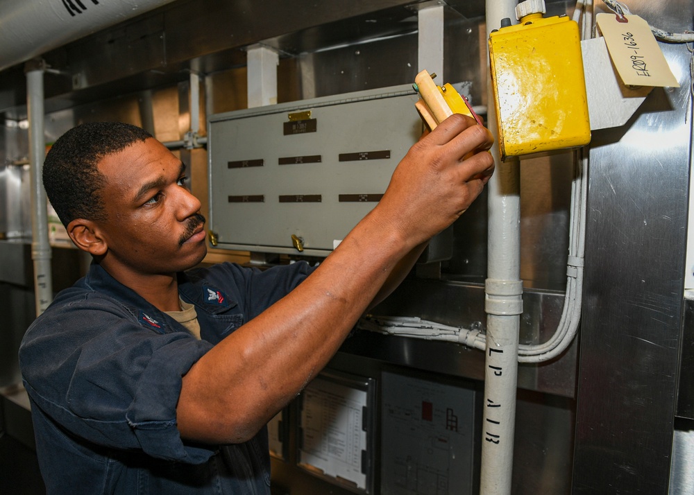 USS Normandy Sailor Performs Routine Maintenance