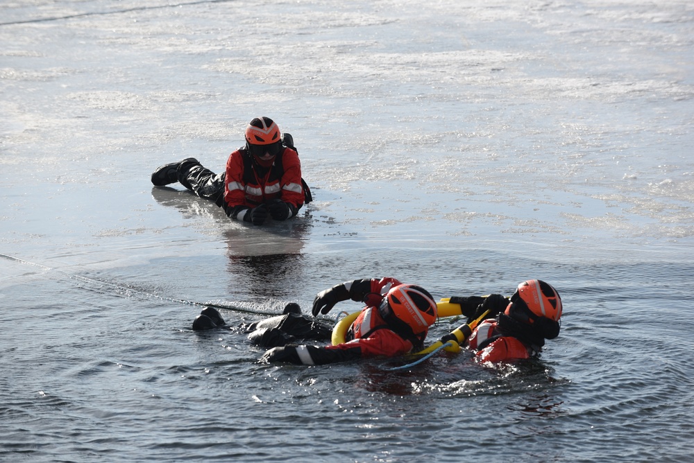 Coast Guard rescue crew members conduct ice rescue training