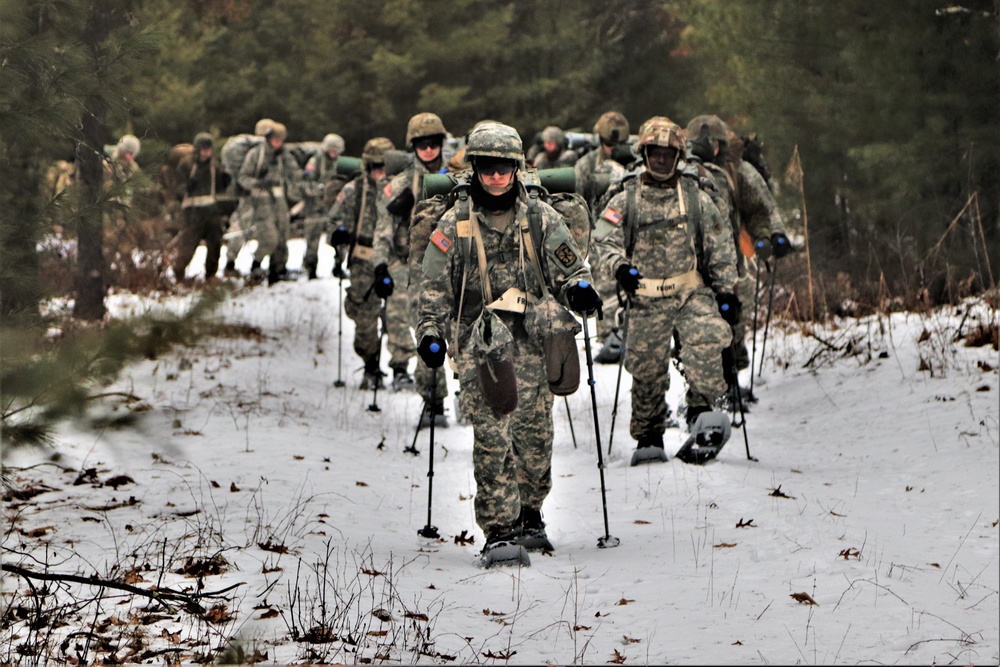 Fort McCoy Cold-Weather Operations Course students practice snowshoeing, ahkio sled use