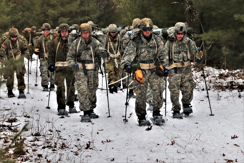 Fort McCoy Cold-Weather Operations Course students practice snowshoeing, ahkio sled use