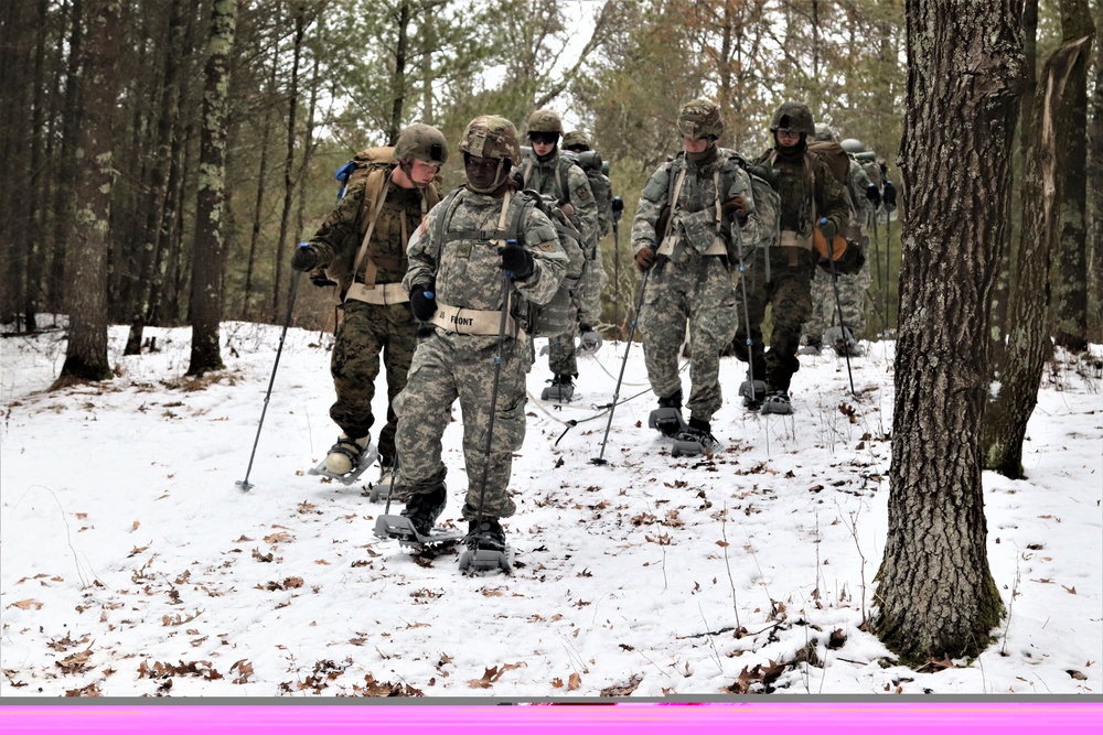 Fort McCoy Cold-Weather Operations Course students practice snowshoeing, ahkio sled use