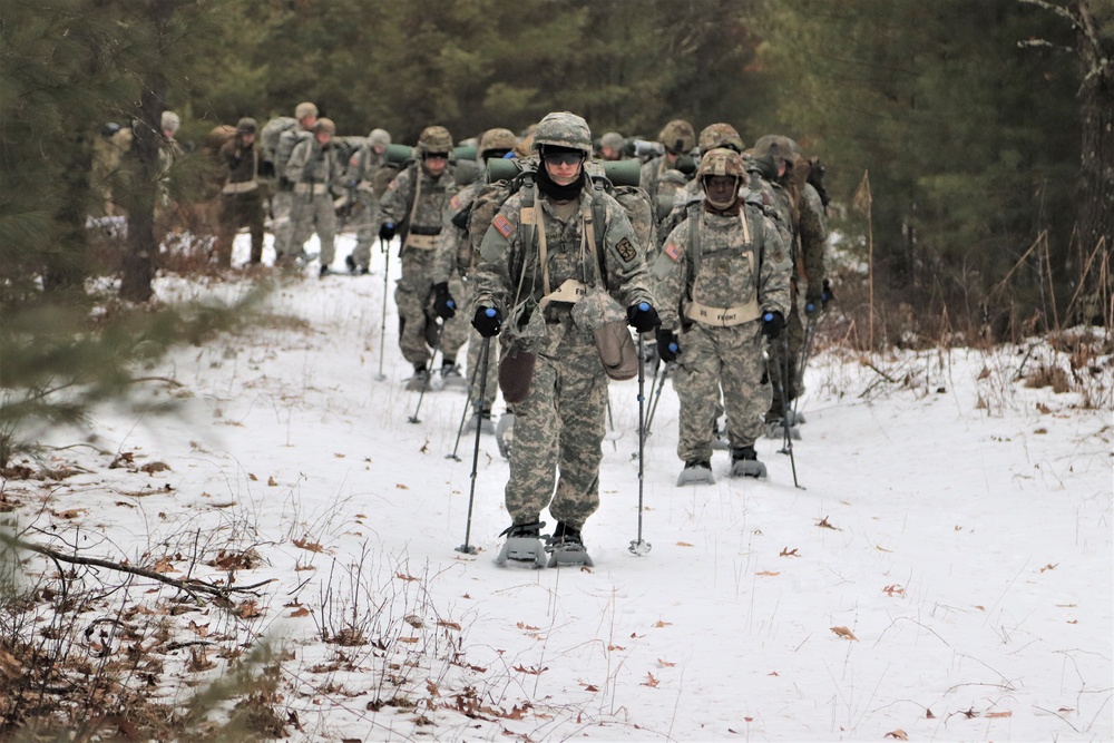 Fort McCoy Cold-Weather Operations Course students practice snowshoeing, ahkio sled use