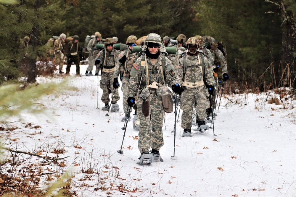 Fort McCoy Cold-Weather Operations Course students practice snowshoeing, ahkio sled use