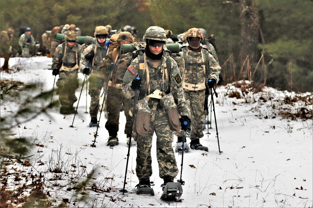 Fort McCoy Cold-Weather Operations Course students practice snowshoeing, ahkio sled use