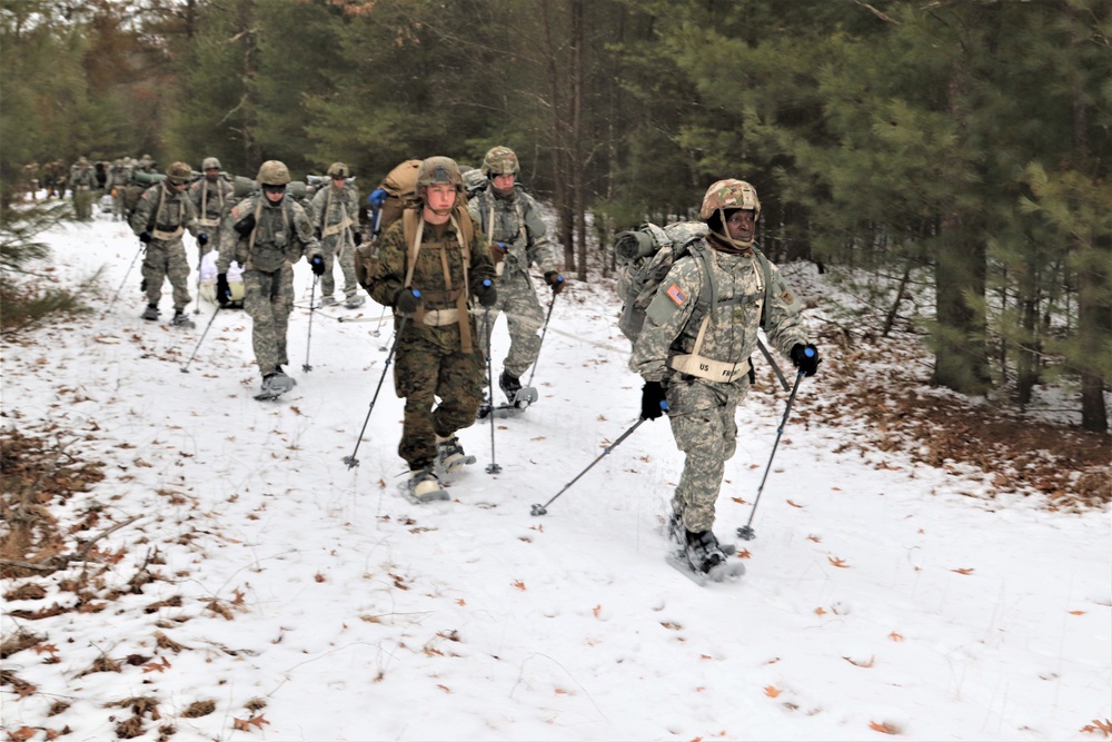 Fort McCoy Cold-Weather Operations Course students practice snowshoeing, ahkio sled use
