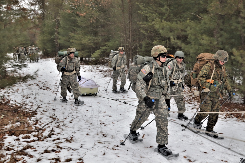 Fort McCoy Cold-Weather Operations Course students practice snowshoeing, ahkio sled use