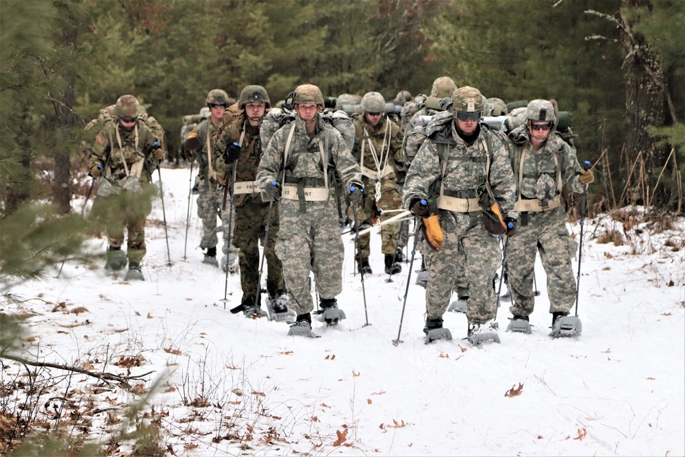Fort McCoy Cold-Weather Operations Course students practice snowshoeing, ahkio sled use