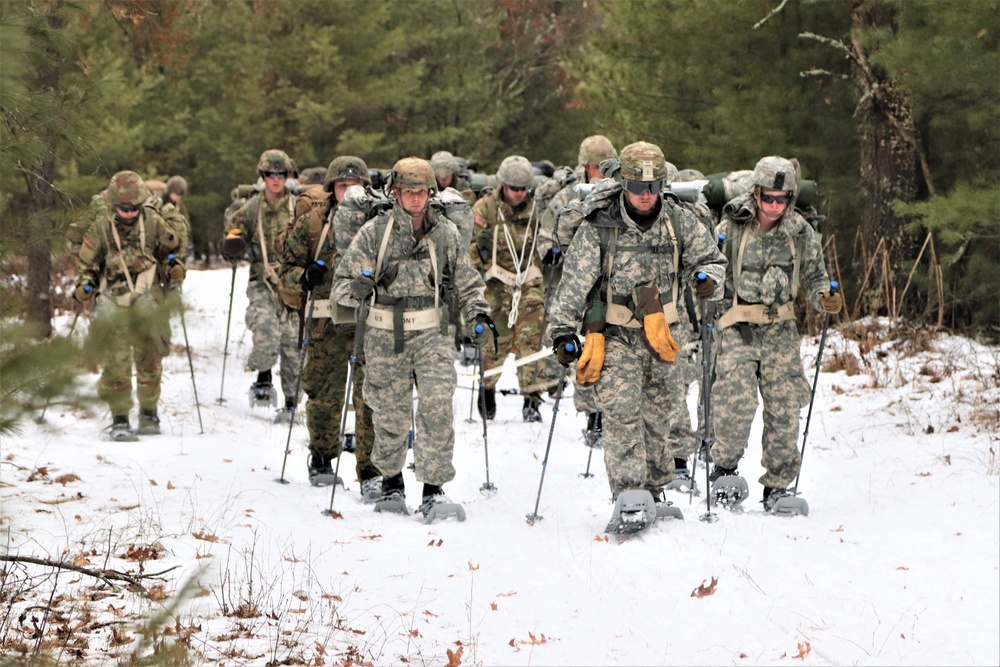 Fort McCoy Cold-Weather Operations Course students practice snowshoeing, ahkio sled use