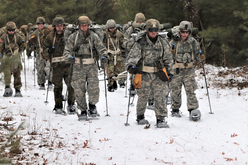 Fort McCoy Cold-Weather Operations Course students practice snowshoeing, ahkio sled use