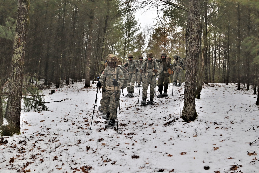 Fort McCoy Cold-Weather Operations Course students practice snowshoeing, ahkio sled use