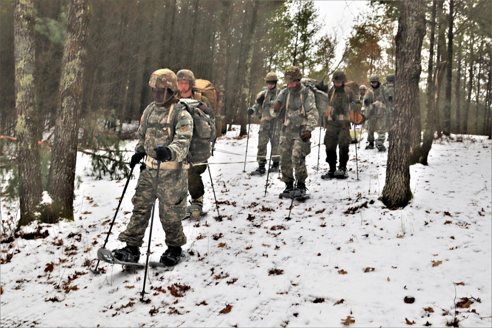 Fort McCoy Cold-Weather Operations Course students practice snowshoeing, ahkio sled use