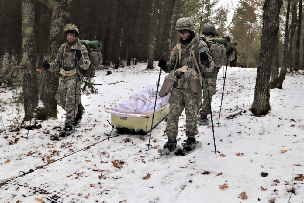 Fort McCoy Cold-Weather Operations Course students practice snowshoeing, ahkio sled use