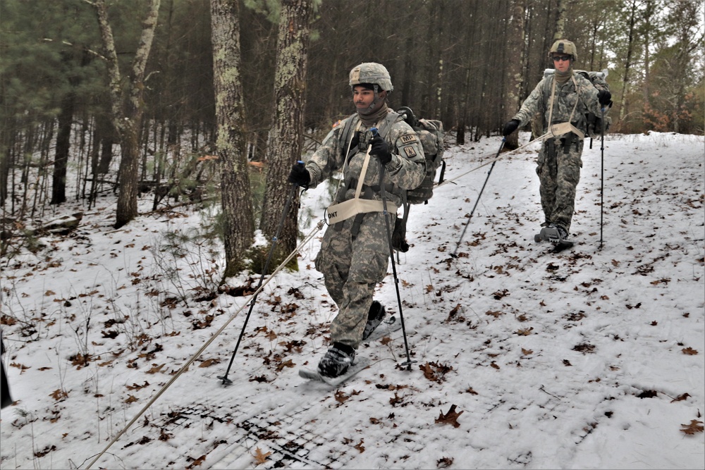 Fort McCoy Cold-Weather Operations Course students practice snowshoeing, ahkio sled use