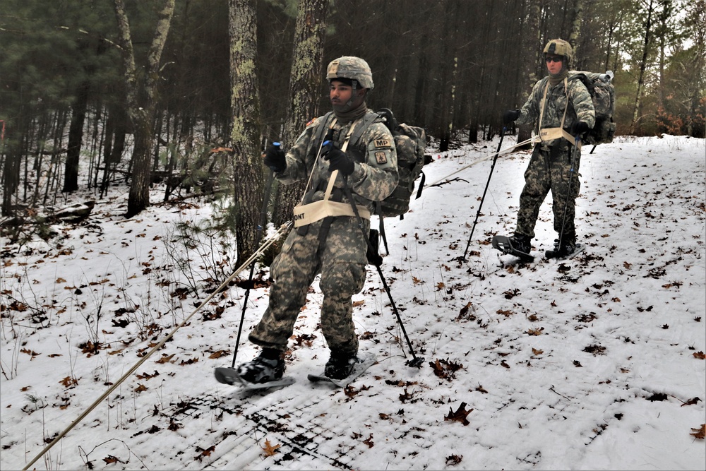 Fort McCoy Cold-Weather Operations Course students practice snowshoeing, ahkio sled use