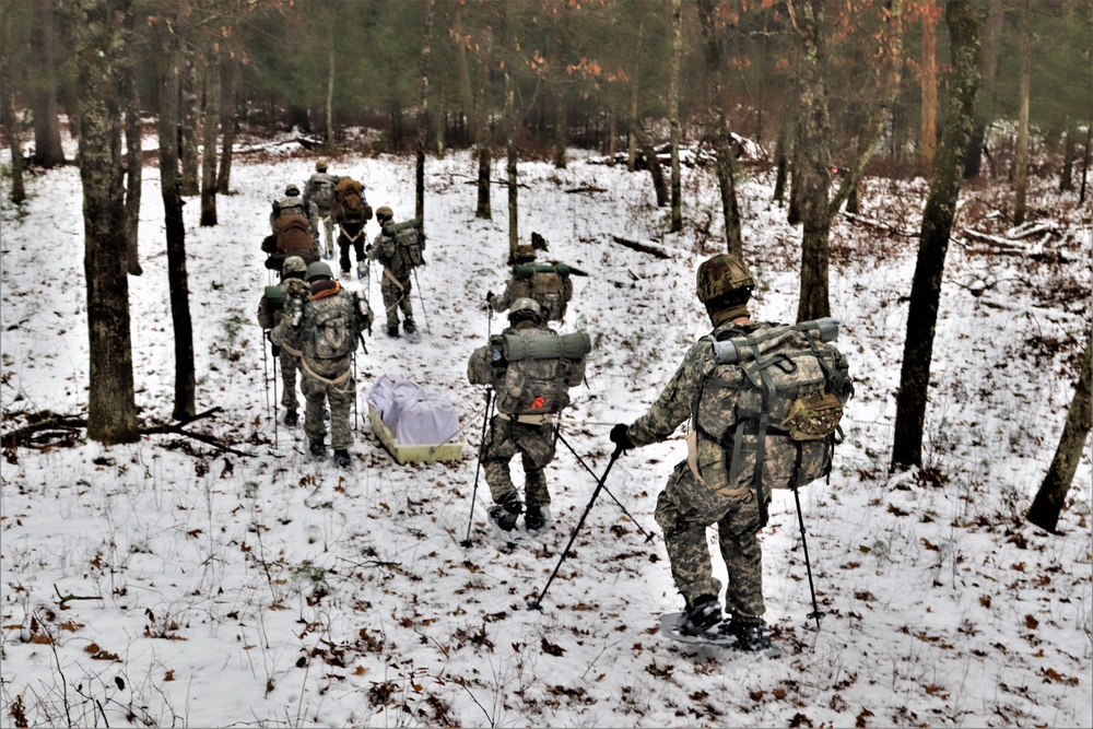 Fort McCoy Cold-Weather Operations Course students practice snowshoeing, ahkio sled use