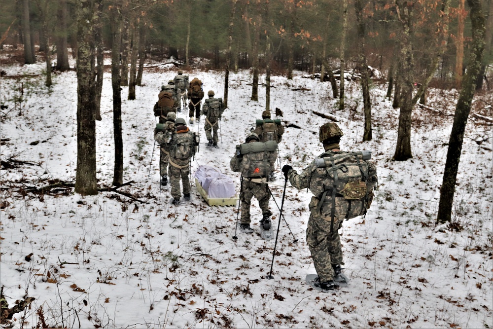Fort McCoy Cold-Weather Operations Course students practice snowshoeing, ahkio sled use