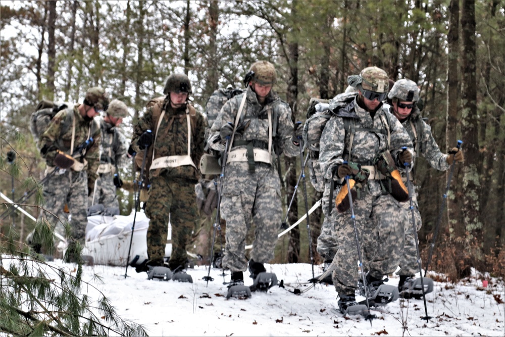 Fort McCoy Cold-Weather Operations Course students practice snowshoeing, ahkio sled use