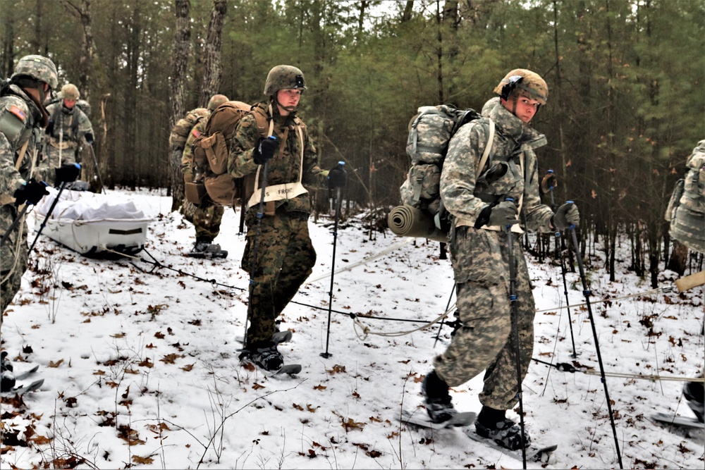 Fort McCoy Cold-Weather Operations Course students practice snowshoeing, ahkio sled use