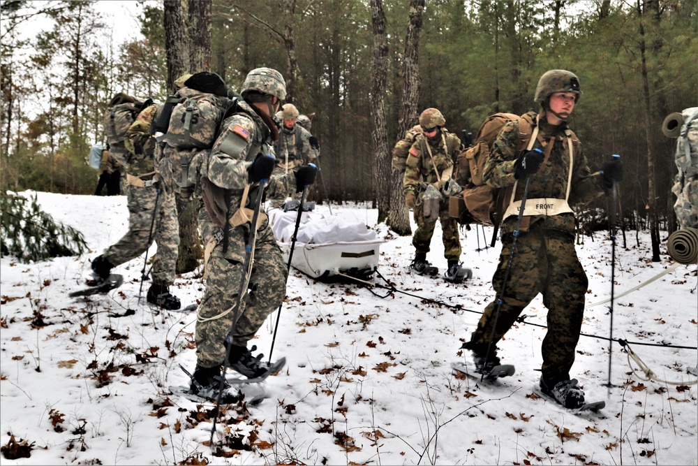 ort McCoy Cold-Weather Operations Course students practice snowshoeing, ahkio sled use