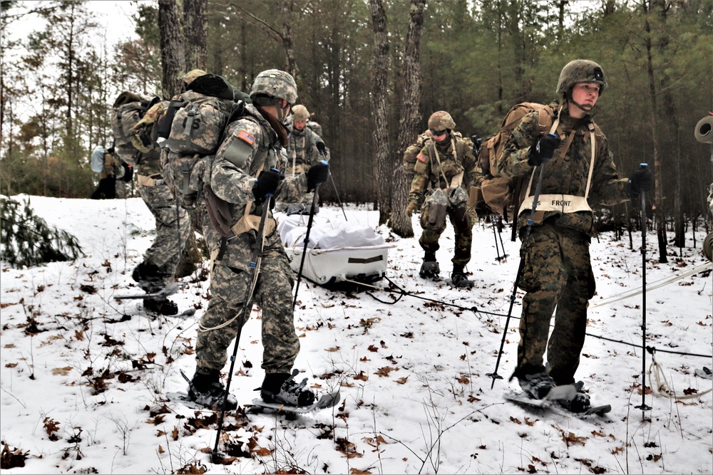 Fort McCoy Cold-Weather Operations Course students practice snowshoeing, ahkio sled use