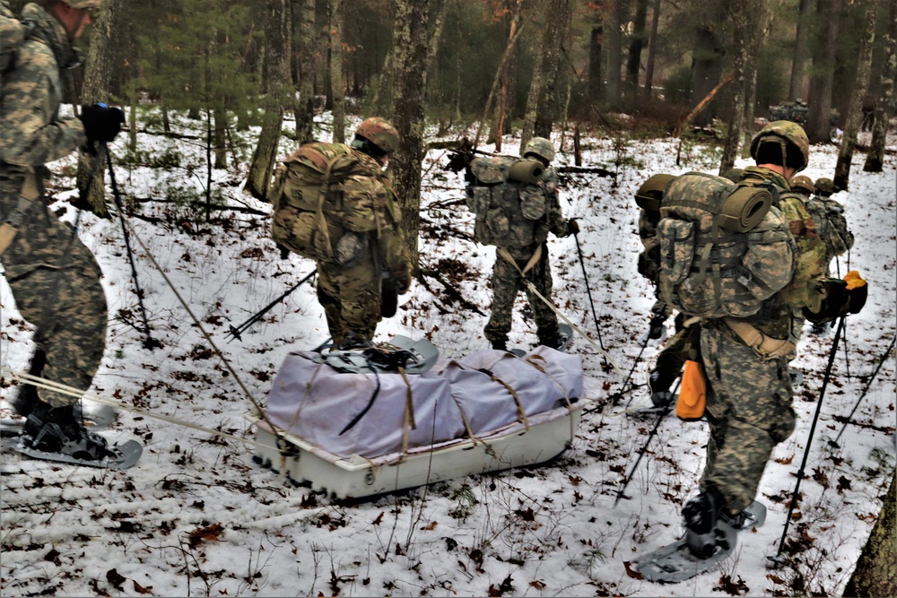 ort McCoy Cold-Weather Operations Course students practice snowshoeing, ahkio sled use