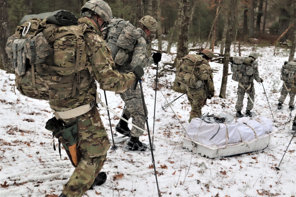 Fort McCoy Cold-Weather Operations Course students practice snowshoeing, ahkio sled use