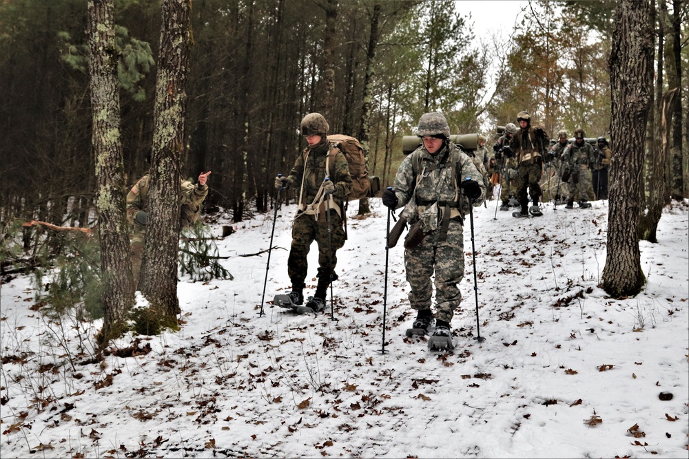 Fort McCoy Cold-Weather Operations Course students practice snowshoeing, ahkio sled use