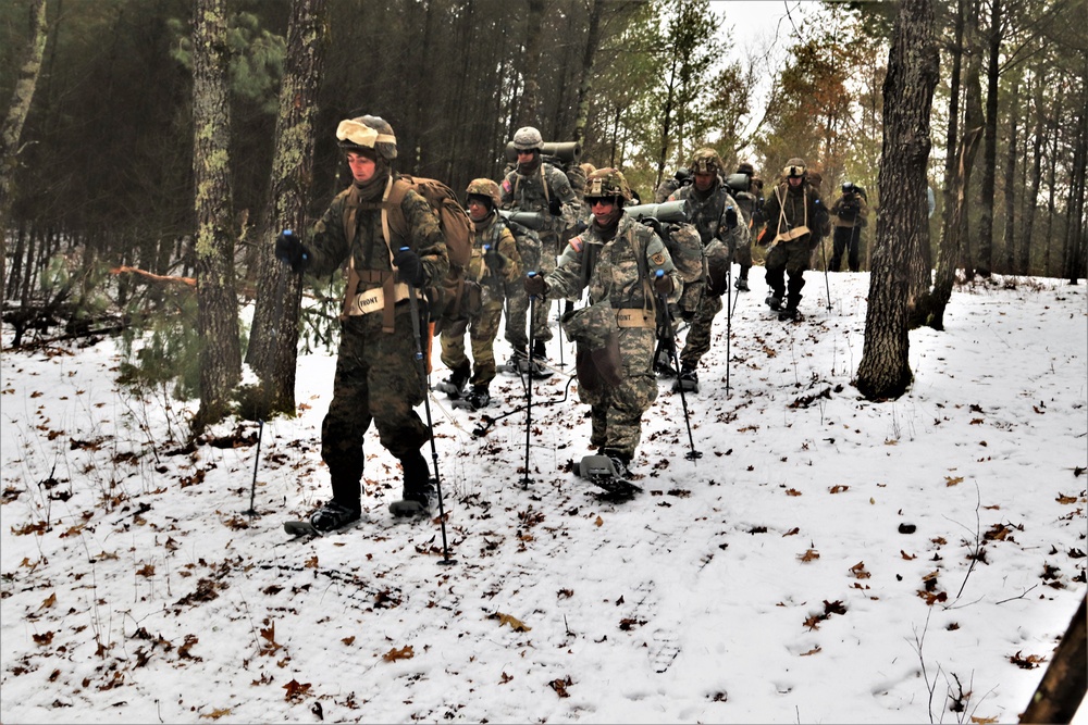 Fort McCoy Cold-Weather Operations Course students practice snowshoeing, ahkio sled use