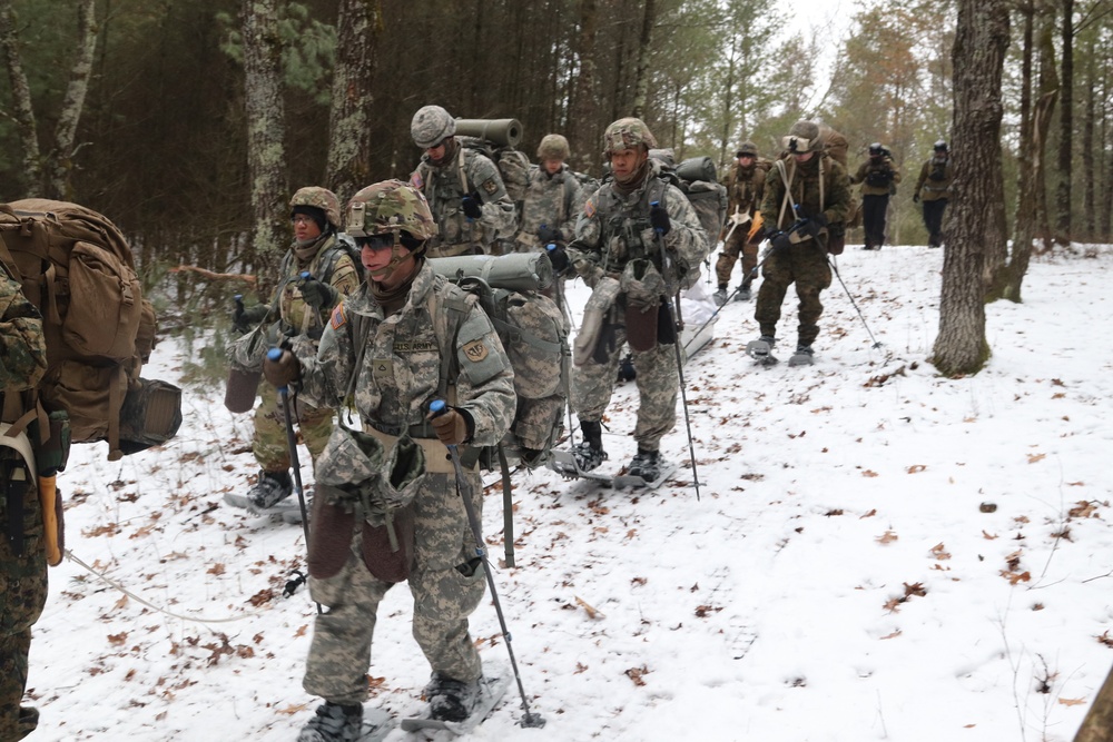 Fort McCoy Cold-Weather Operations Course students practice snowshoeing, ahkio sled use