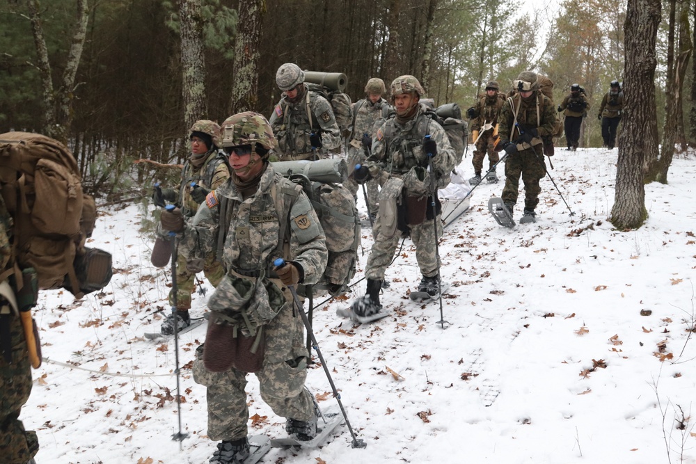 Fort McCoy Cold-Weather Operations Course students practice snowshoeing, ahkio sled use