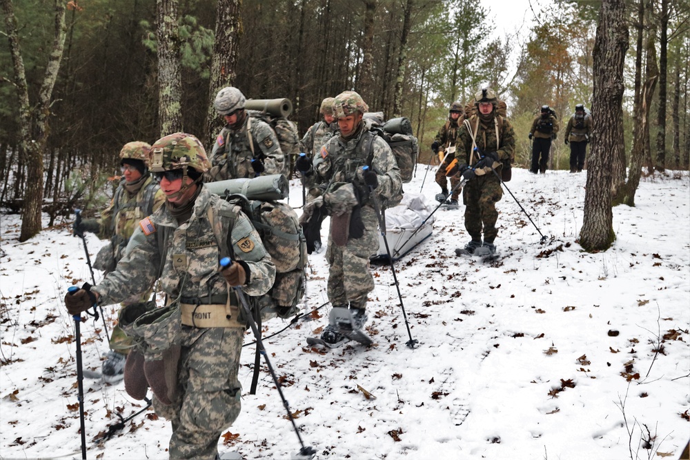 ort McCoy Cold-Weather Operations Course students practice snowshoeing, ahkio sled use