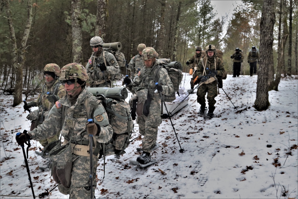 Fort McCoy Cold-Weather Operations Course students practice snowshoeing, ahkio sled use