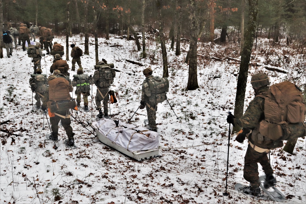 Fort McCoy Cold-Weather Operations Course students practice snowshoeing, ahkio sled use