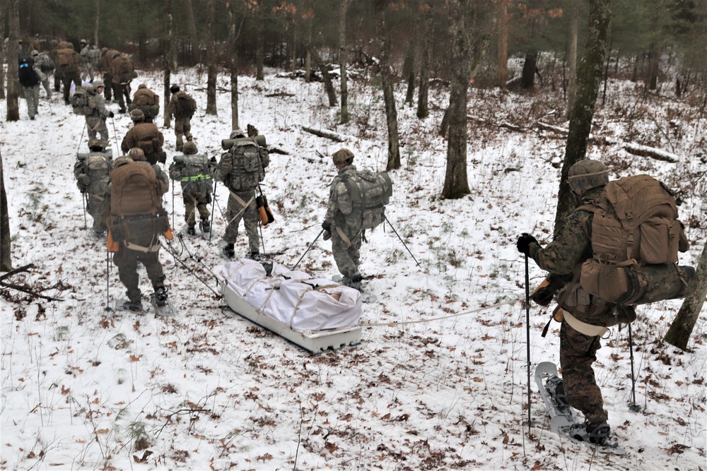 Fort McCoy Cold-Weather Operations Course students practice snowshoeing, ahkio sled use