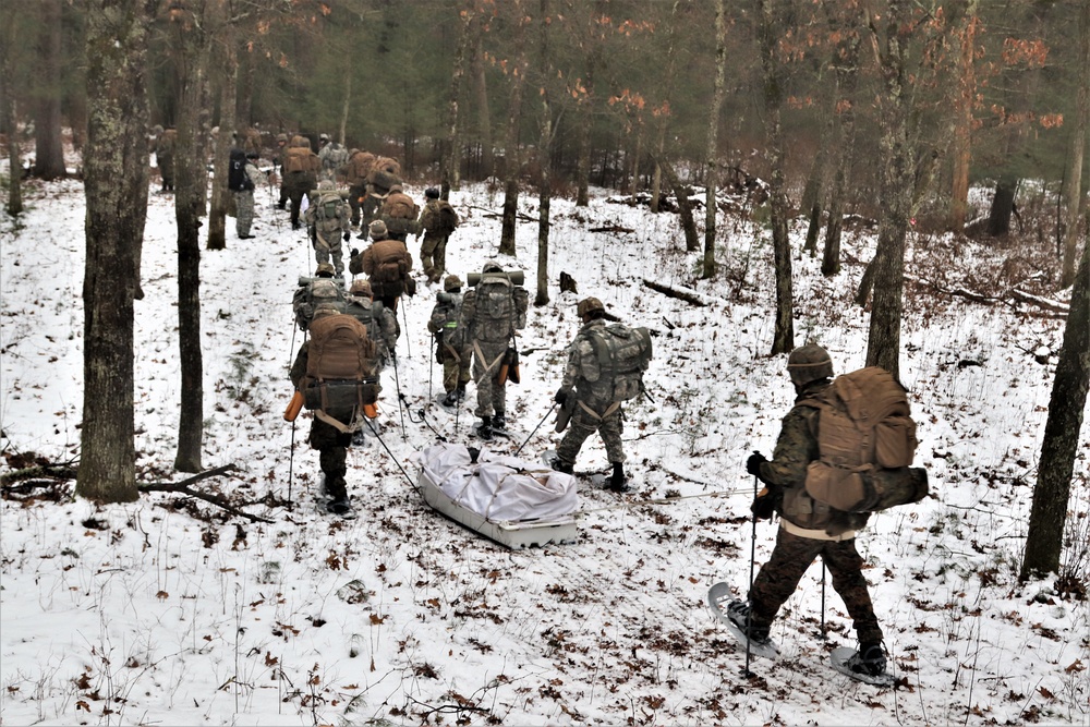 Fort McCoy Cold-Weather Operations Course students practice snowshoeing, ahkio sled use