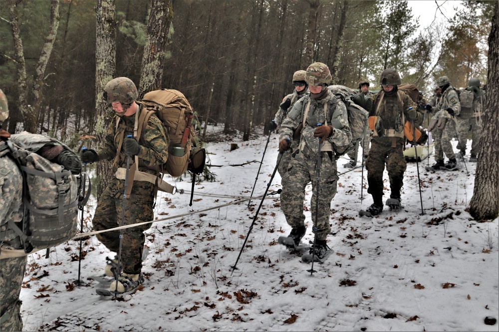 Fort McCoy Cold-Weather Operations Course students practice snowshoeing, ahkio sled use