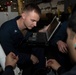 Nimitz sailors do maintenence in hangar bay
