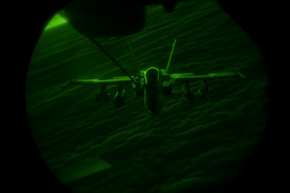 Deployed KC-10 refuels F/A-18 Hornets