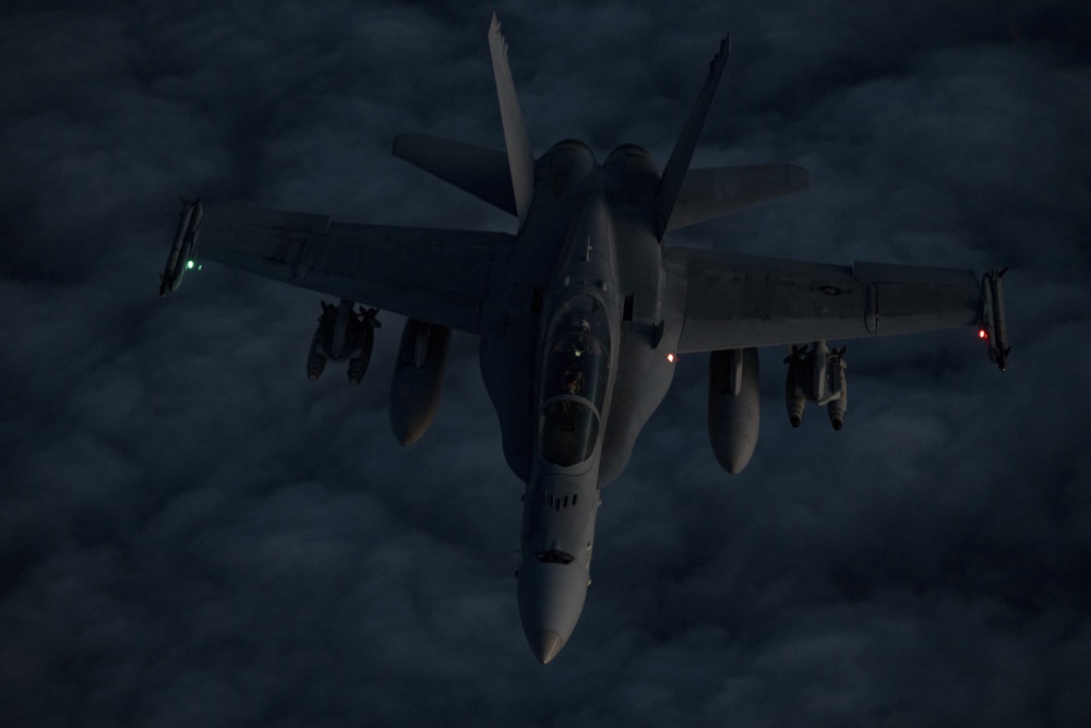 Deployed KC-10 refuels F/A-18 Hornets