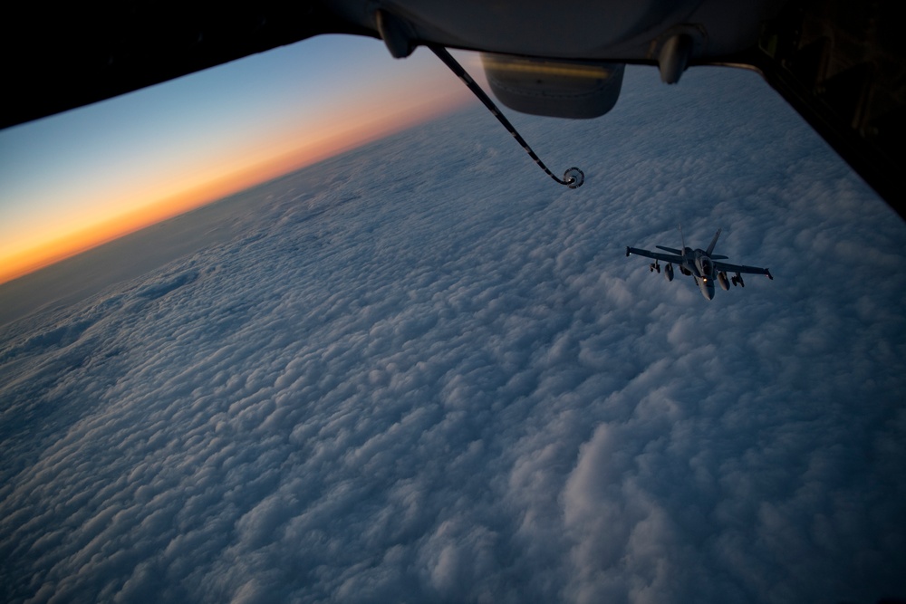 Deployed KC-10 refuels F/A-18 Hornets