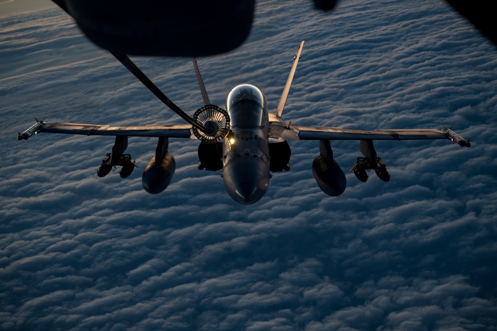 Deployed KC-10 refuels F/A-18 Hornets