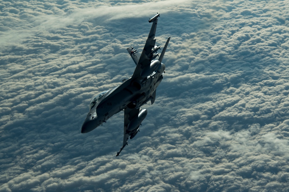 Deployed KC-10 refuels F/A-18 Hornets