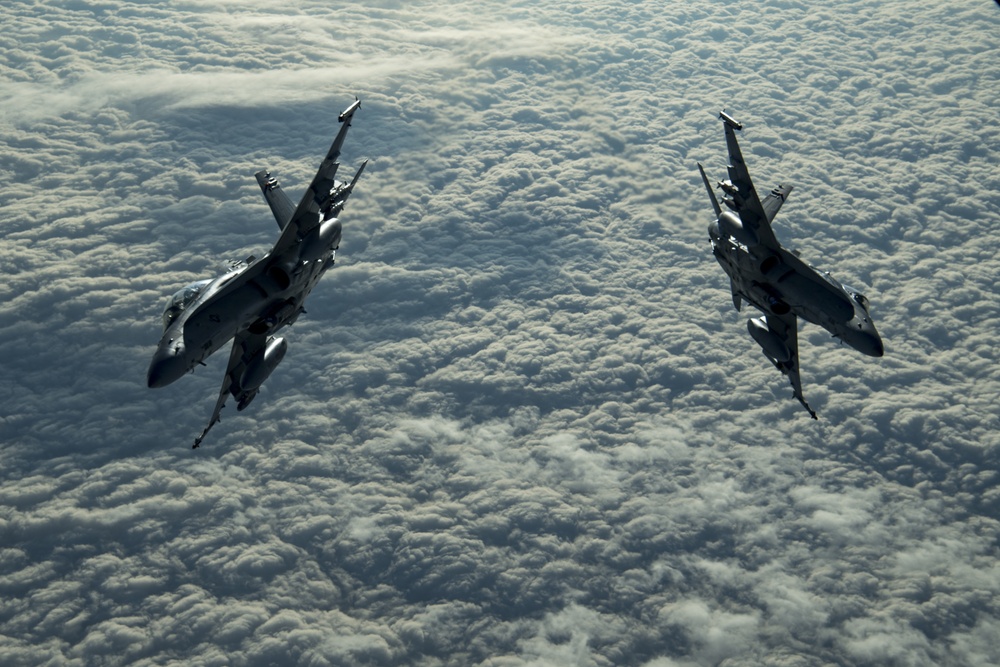 Deployed KC-10 refuels F/A-18 Hornets