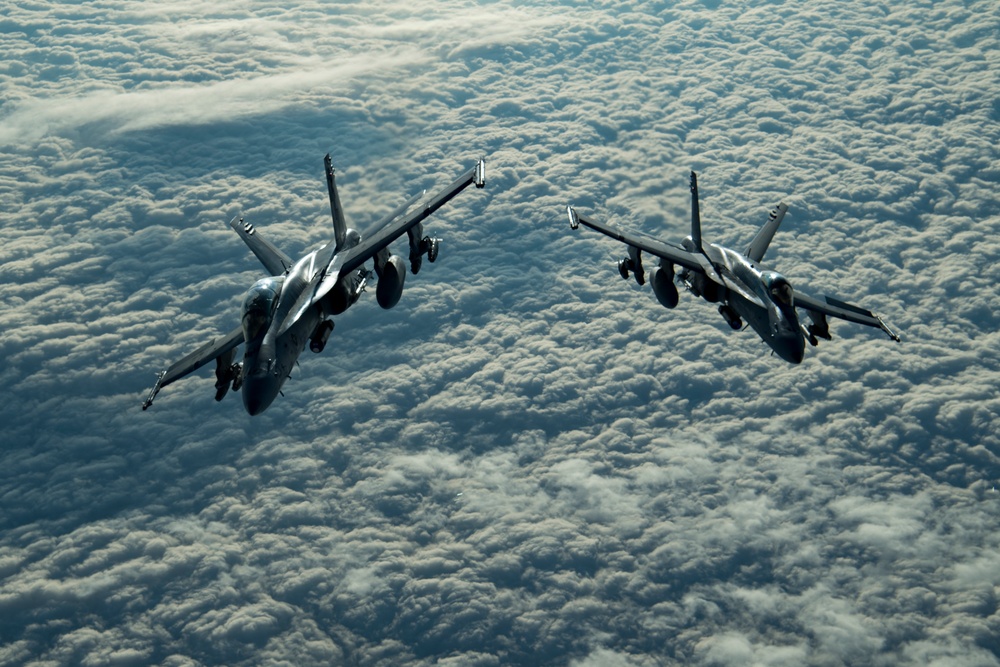 Deployed KC-10 refuels F/A-18 Hornets