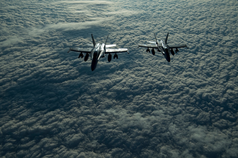 Deployed KC-10 refuels F/A-18 Hornets