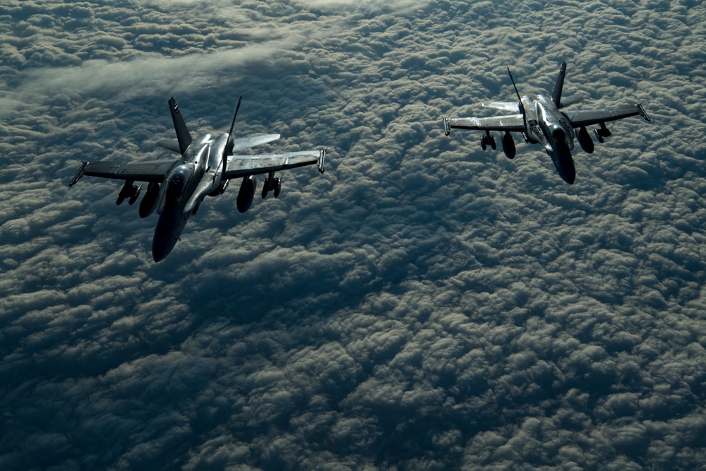 Deployed KC-10 refuels F/A-18 Hornets