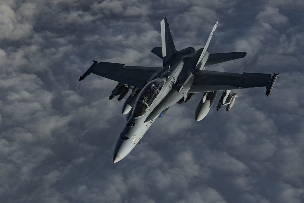 Deployed KC-10 refuels F/A-18 Hornets