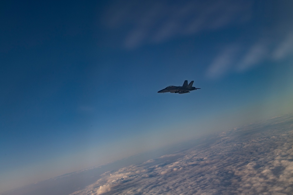 Deployed KC-10 refuels F/A-18 Hornets