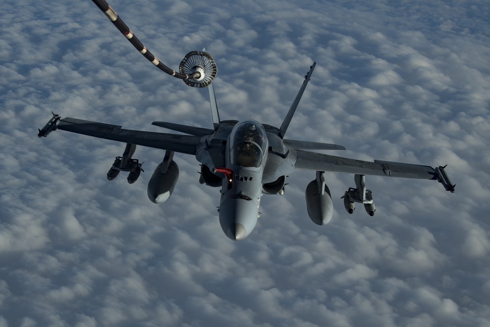 Deployed KC-10 refuels F/A-18 Hornets